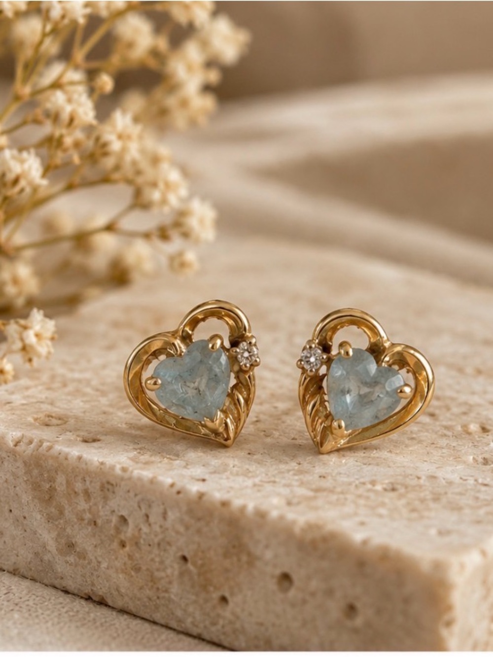 Gold heart studded earrings with light blue stone and diamond accents